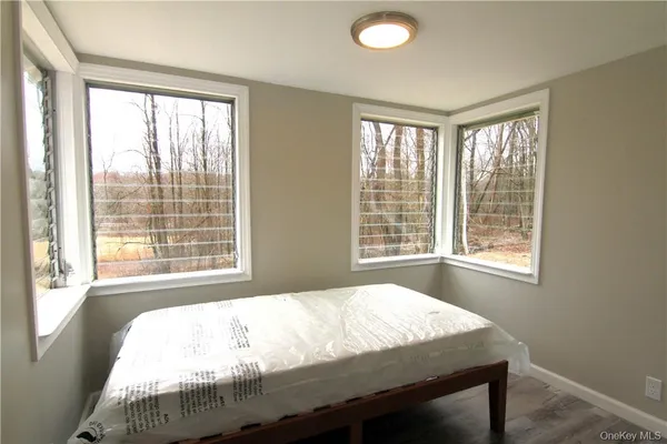 a bed sitting in a bedroom next to a window
