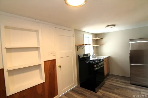 a stove top oven sitting inside of a kitchen