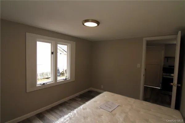 a bed sitting in a bedroom next to a window