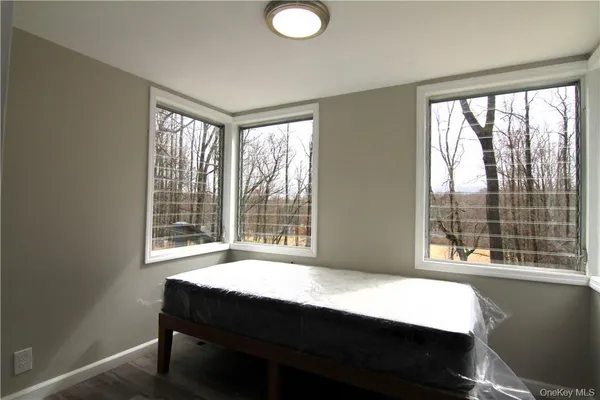 a bedroom with a bed and a large window