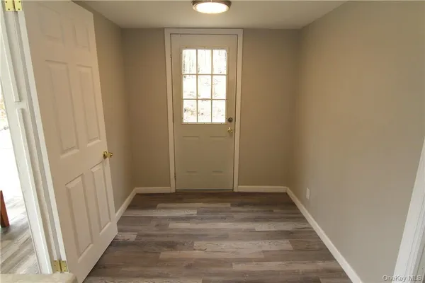 a view of room with window and hardwood floor