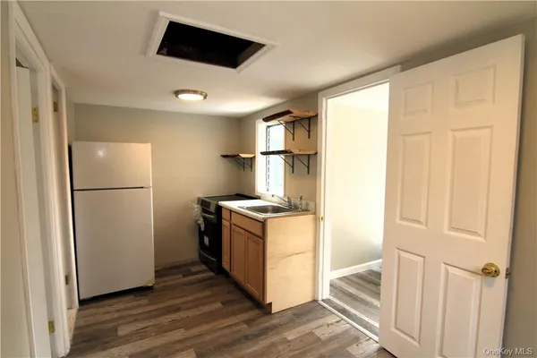 a kitchen with a refrigerator and a stove top oven