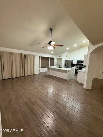 a kitchen with stainless steel appliances a refrigerator sink and white cabinets