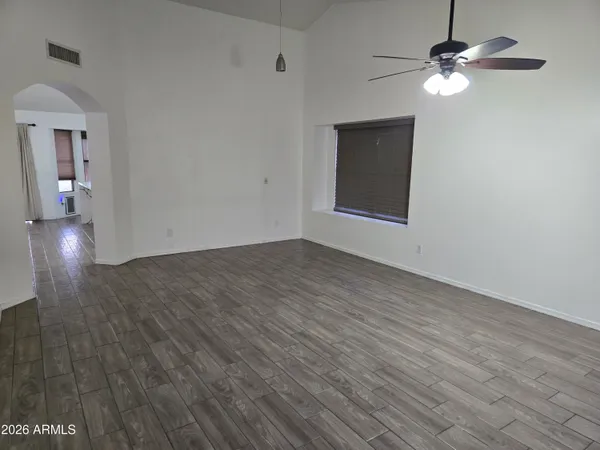 wooden floor in an empty room with a window