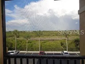 a view of a balcony with table and chairs