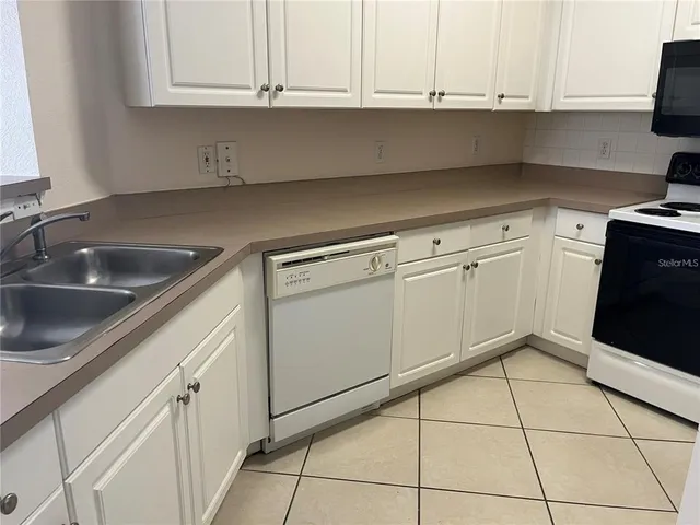 a kitchen with appliances cabinets and a sink