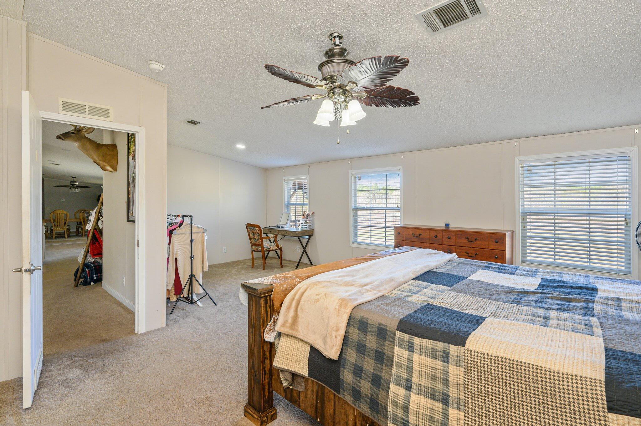 1078 Wallace Road DeFuniak Springs, FL 32433 - Photo 15 of 46 a bedroom with a bed and a chandelier