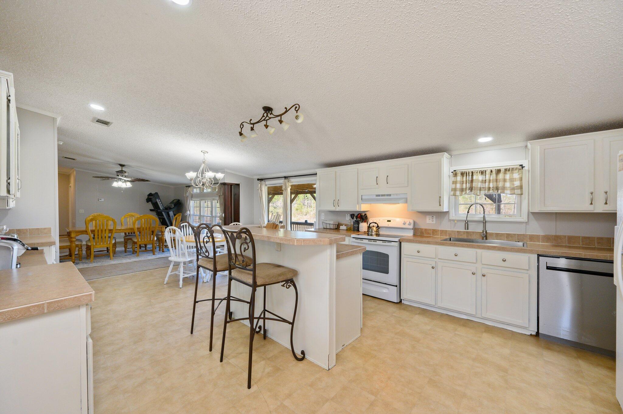 1078 Wallace Road DeFuniak Springs, FL 32433 - Photo 2 of 46 a kitchen with lots of counter top space and dining table