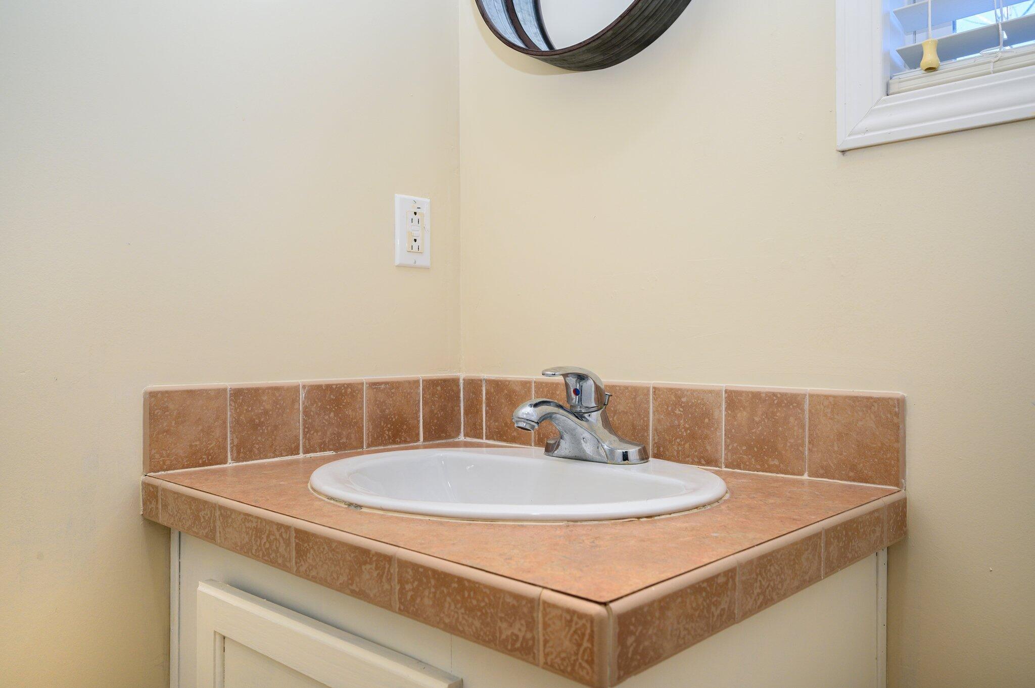 1078 Wallace Road DeFuniak Springs, FL 32433 - Photo 25 of 46 a bathroom with a sink and a mirror