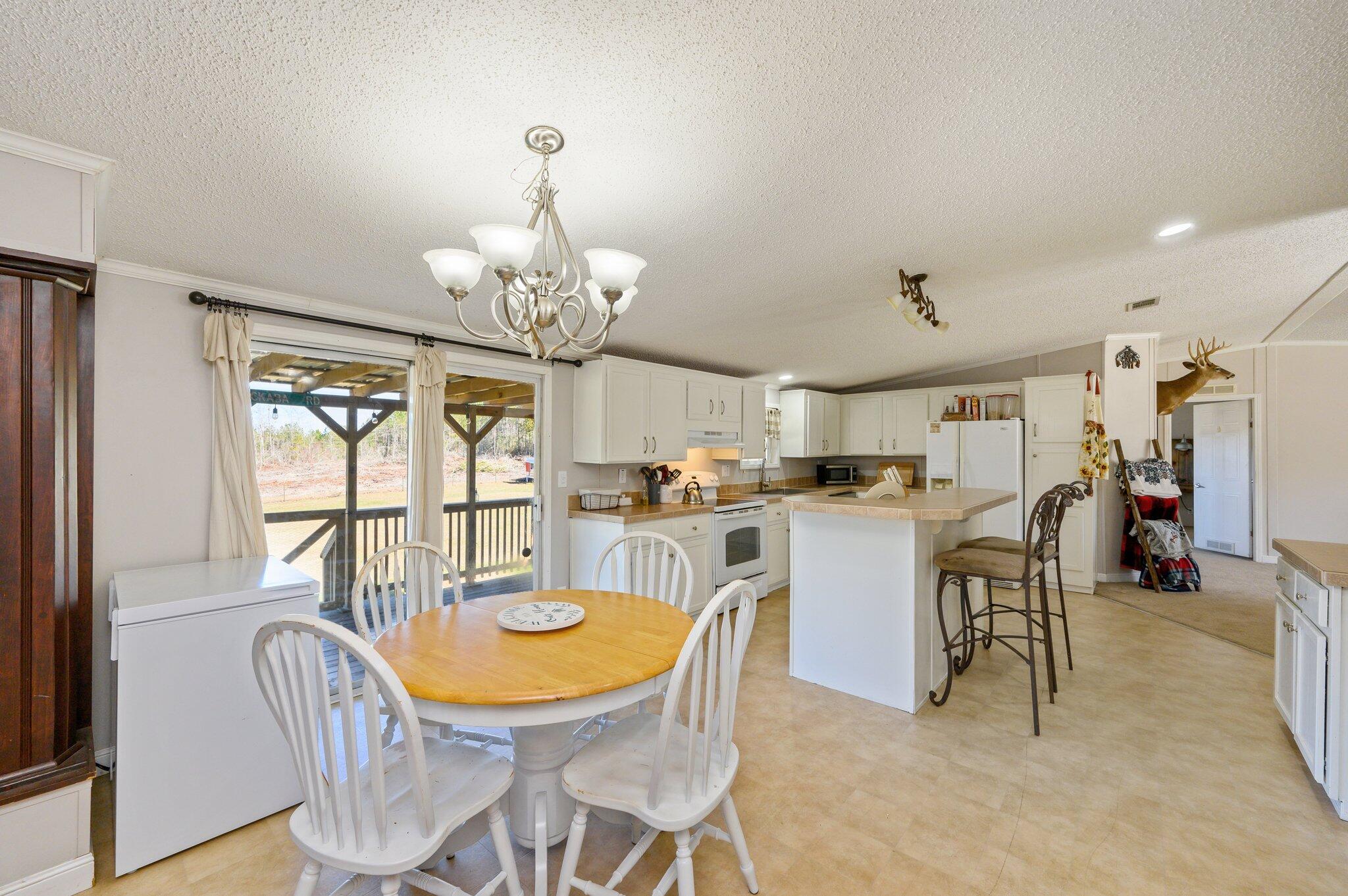 1078 Wallace Road DeFuniak Springs, FL 32433 - Photo 8 of 46 a view of a dining room with furniture window and outside view