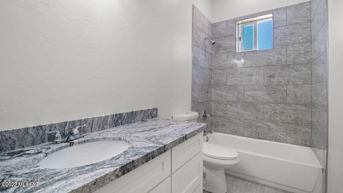 286 Guaymas Rio Rico, AZ 85648 - Photo 10 of 12 a bathroom with a granite countertop sink toilet and shower