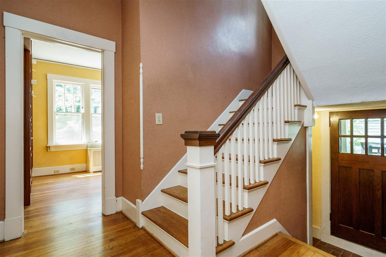 311 Hillcrest Road Raleigh, NC 27605 - Photo 19 of 30 staircase up leads to 4 bedrooms and a full bathroom, staircase down takes you to the full basement with 6'4" ceiling height, great for storage, utility space, and laundry. staircase