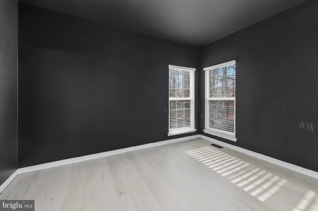 a view of staircase with lots of frames and wooden floor
