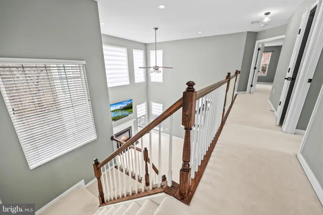 an empty room with windows and ceiling fan