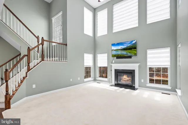 a view of an empty room with a fireplace and a window