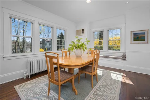 a dining room with furniture wooden floor and a rug