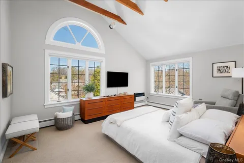 a bedroom with furniture and a flat screen tv