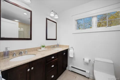 a bathroom with a granite countertop sink mirror and double