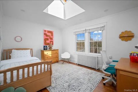 a bedroom with furniture and a window