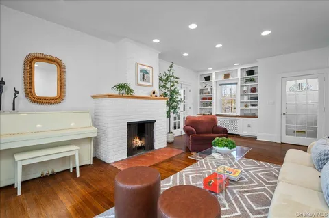 a living room with furniture a fireplace and wooden floor
