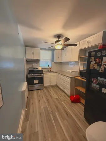 a kitchen with granite countertop a stove and a sink