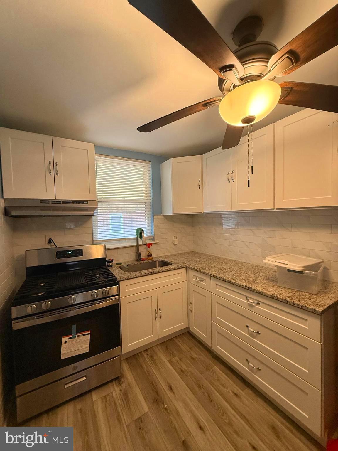 4401 Bleigh Avenue, Unit 2 Philadelphia, PA 19136 - Photo 13 of 25 a kitchen with granite countertop a stove and a sink