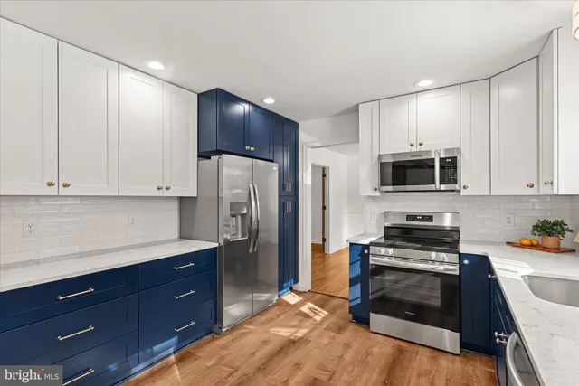 a kitchen with stainless steel appliances a stove microwave and refrigerator