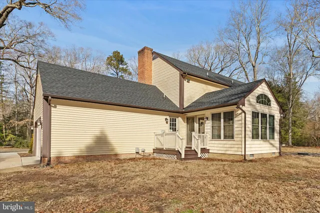 a view of a white house with a street