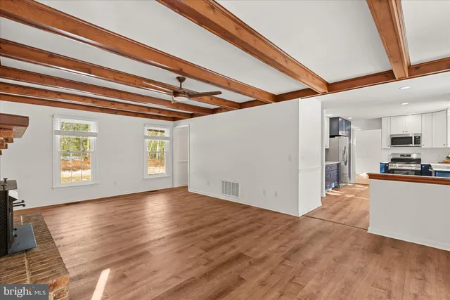 a view of a kitchen with wooden floor and a kitchen