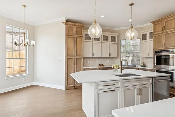 a kitchen that has a lot of cabinets and refrigerator
