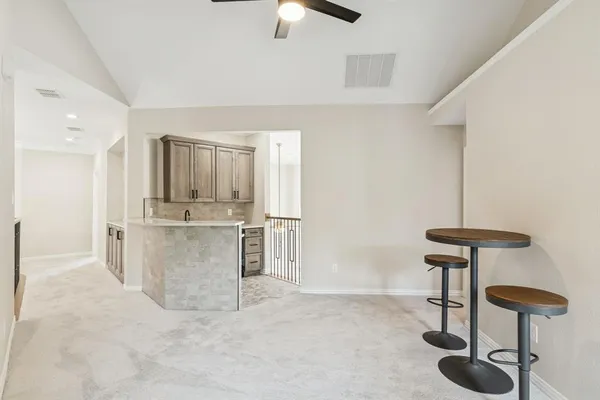 a view of kitchen with furniture and refrigerator