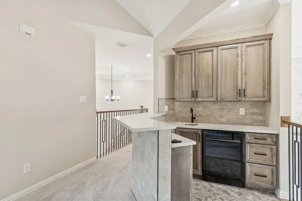 a kitchen with a sink cabinets appliances and a window