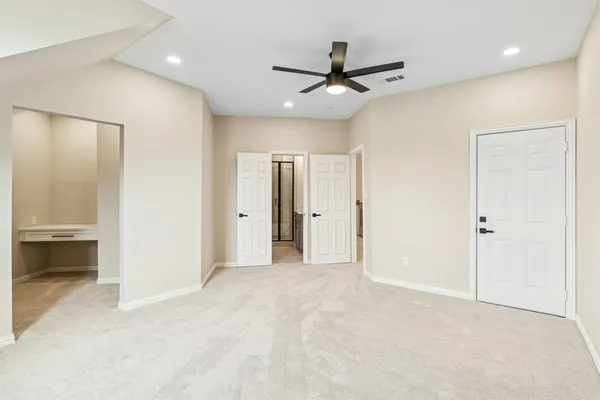 a view of an empty room and a ceiling fan