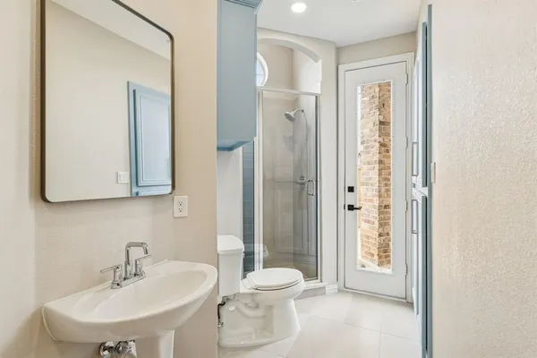 a bathroom with a toilet a sink and a mirror