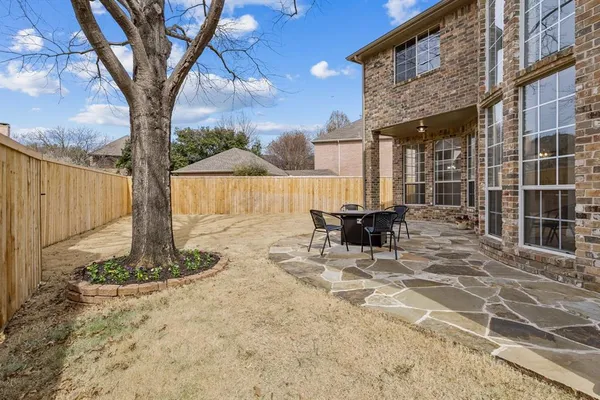a view of a patio with a table chairs and a fire pit