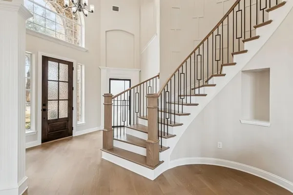 a view of entryway and hall with wooden floor