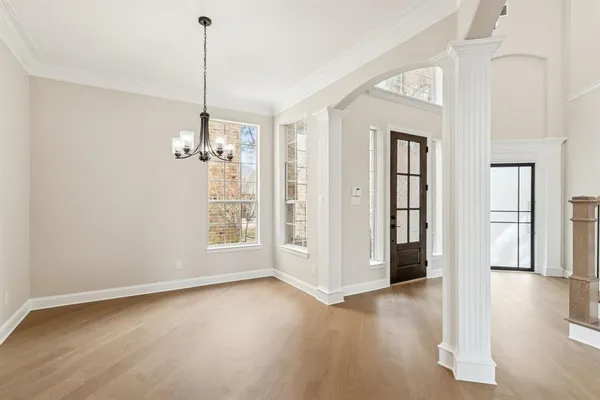a view of a room with wooden floor staircase and a living room