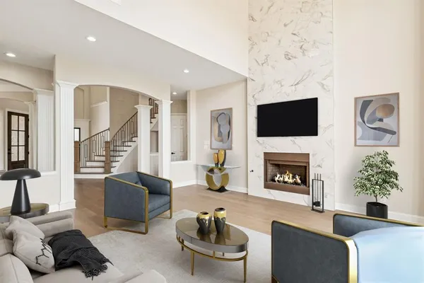 a living room with furniture a fireplace and a flat screen tv