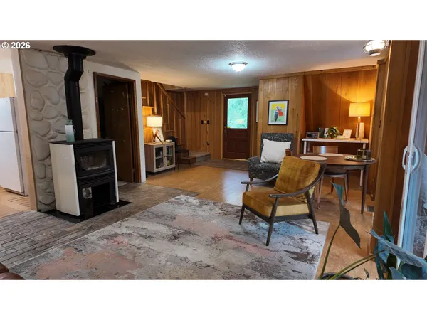 a kitchen with a table chairs and a refrigerator