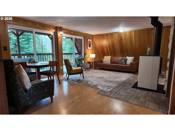 a living room with furniture and a floor to ceiling window