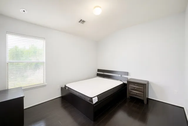 a room with a bed and a window