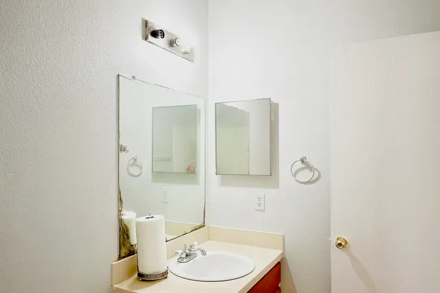 a view of bathroom and hallway