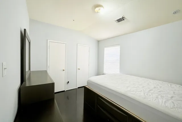 a bedroom with a bed and a dresser