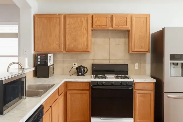 a kitchen with a sink a stove and cabinets