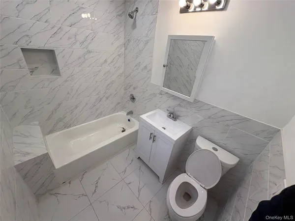 a bathroom with a bathtub sink and toilet