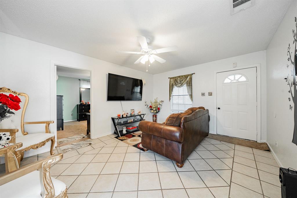 1524 Crowell Road Kaufman, TX 75142 - Photo 12 of 28 a living room with furniture and a flat screen tv