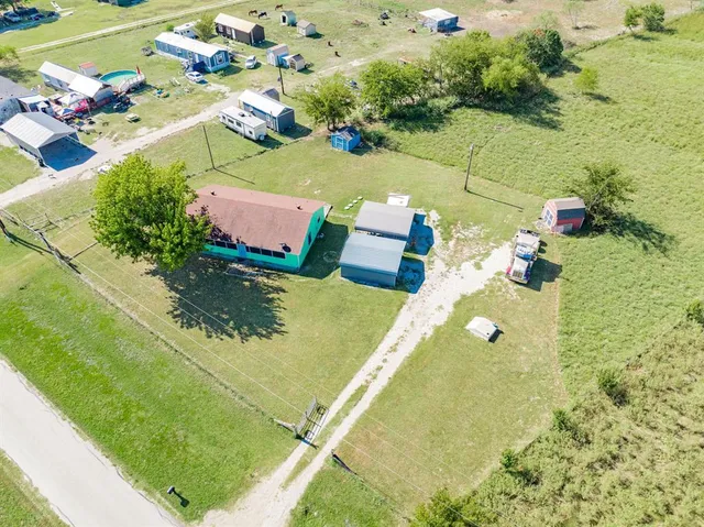 an aerial view of a residential houses with outdoor space