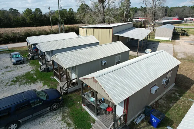 a view of a patio with table and chairs with wooden floor and fence