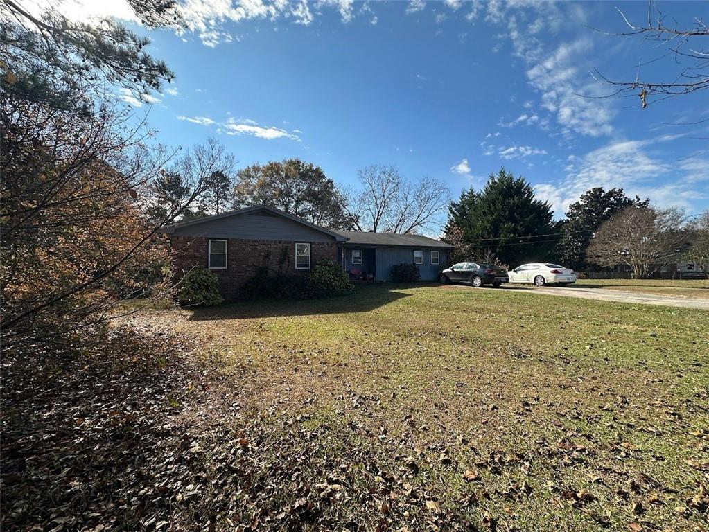 2170 Beaver Shop Road Marietta, GA 30066 - Photo 3 of 6 a view of a house with a yard