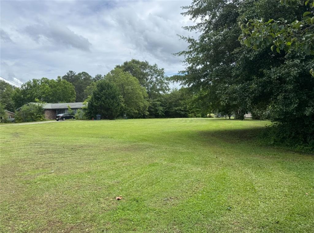 2170 Beaver Shop Road Marietta, GA 30066 - Photo 5 of 6 a view of a green field with wooden fence